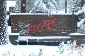 A brick wall with the word 'ESCAPE' painted in red. - Steps from Snow Summit Resort! Ski-In Ski-Out! Wifi & Cable! (Big Bear Lake)