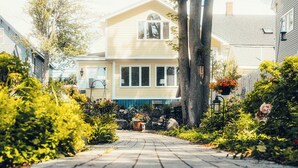 A house with a front yard, a pathway leading to the front door, and a small garden area.