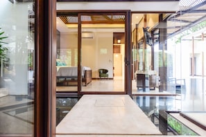 Enjoy a serene retreat with a large sliding door leading to a balcony and a comfortable bed.