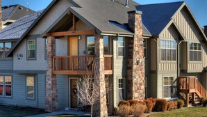 A multi-story residential building with a balcony, stone pillars, and a well-maintained lawn. - Reduced January Rates!  Great Location. 5starReviews. 3 Bed, 2 Bath with Views (Park City)