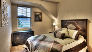 A bedroom with a bed, a nightstand, a dresser, a window with blinds, and a painting on the wall. - Reduced January Rates!  Great Location. 5starReviews. 3 Bed, 2 Bath with Views (Park City)