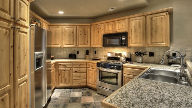 A kitchen with wooden cabinets, a stainless steel refrigerator, a microwave, a stove, and granite countertops. - Reduced January Rates!  Great Location. 5starReviews. 3 Bed, 2 Bath with Views (Park City)