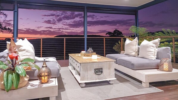 A modern outdoor seating area with a sofa, coffee table, and decorative items. - Reconnect Your Mind, Body and Soul... (Wongawallan)