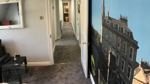 Un couloir menant à une salle de bain, avec une porte située sur le côté droit.