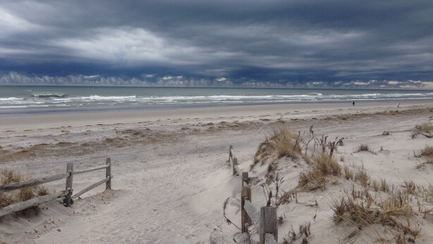 A beach with a wooden fence and dunes. - Direct Beachfront Condo With Great Ocean Views From Couch Or On The Porch (North Wildwood)