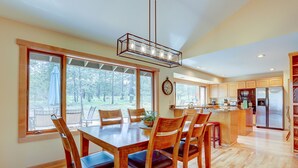 A spacious kitchen with wooden cabinets, a stainless steel refrigerator, and a large island with a sink. - 16 Yellow Pine - Gorgeous Golf Course, Covered Outdoor Living, Hot Tub, 3 King bedrooms, Bocce (Bend)