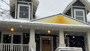 A two-story house with a front porch, a wooden door, and a set of stairs leading to the entrance. - ★Family Friendly, Safe, Amenities, 3 bedrms/3 baths,WIFI, Parking (Portland)