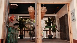 A hotel entrance with a wrought iron gate, potted plants, and a sign reading "HOTEL". - Astuto Boutique Jerez - Adults Only (Jerez de la Frontera)