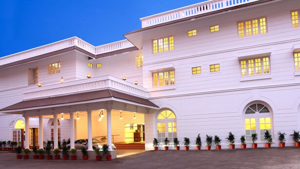 A large, multi-story building with a covered entrance and multiple windows. - Hotel Luciyapalace (Thrissur)