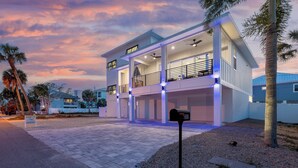 A modern two-story house with a covered porch, a mailbox, and a driveway.