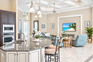 A spacious living area with a kitchen, a dining table, and a comfortable seating arrangement.