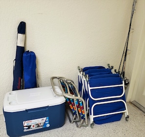 A storage unit, a fishing rod, and a cart with fishing rods.