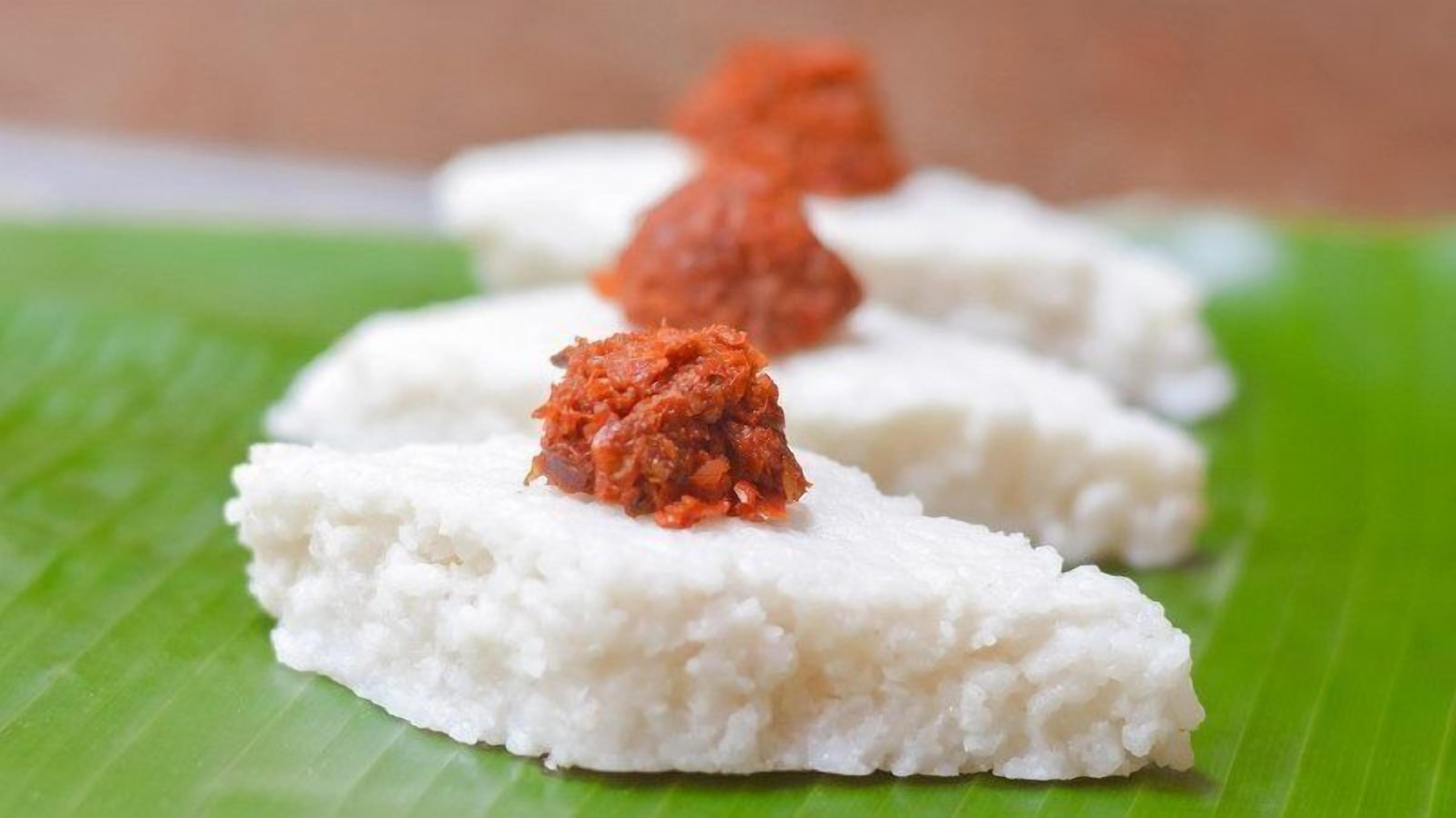 Three white, textured food items on a green leaf.