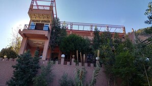 A multi-story building with a balcony on the upper level, surrounded by greenery. - Dar Soulaimane Ourika (Ourika)