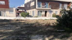 A dog walking on a dirt path in a grassy area with buildings in the background. - Villa in a very quiet and nice neighborhood. Dogs allowed. Jacuzzi possible. (Fuengirola)