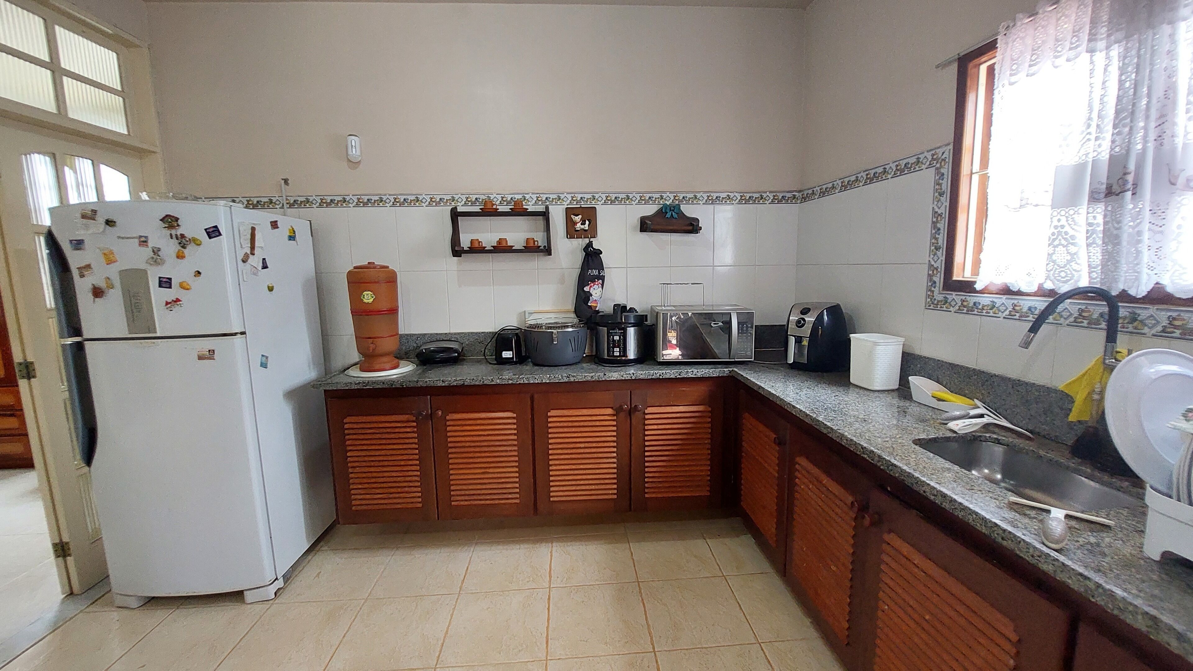 A compact kitchen with a refrigerator, stove, and sink.
