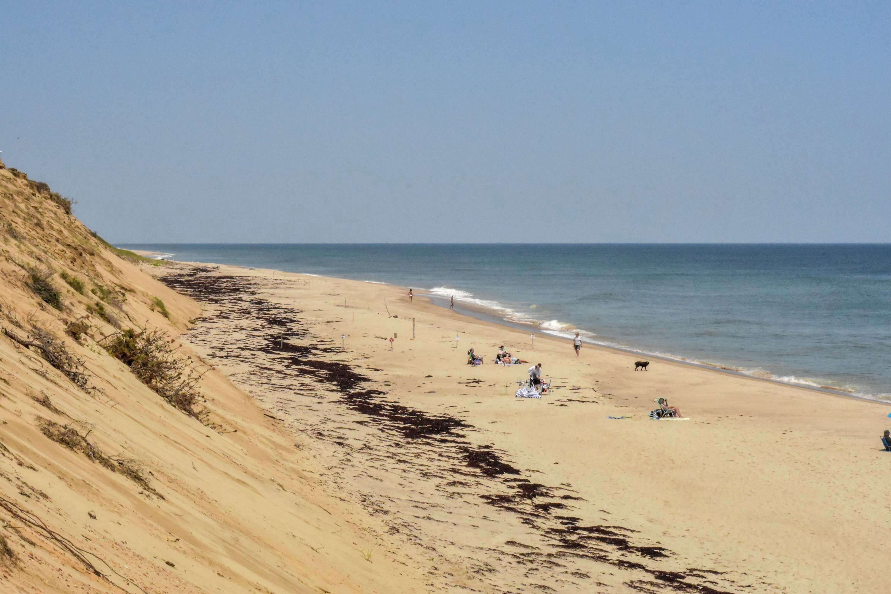 A beach with a sandy shore and a gentle slope on the left.