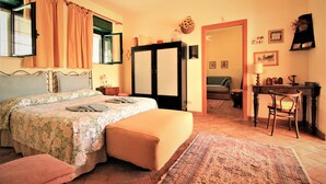 A bedroom with a bed, a desk, and a chair. - Between Catania and Syracuse,countryside Villa  with private pool 1km from beach (Brucoli)