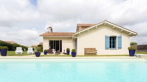 A two-story building with a swimming pool in front.