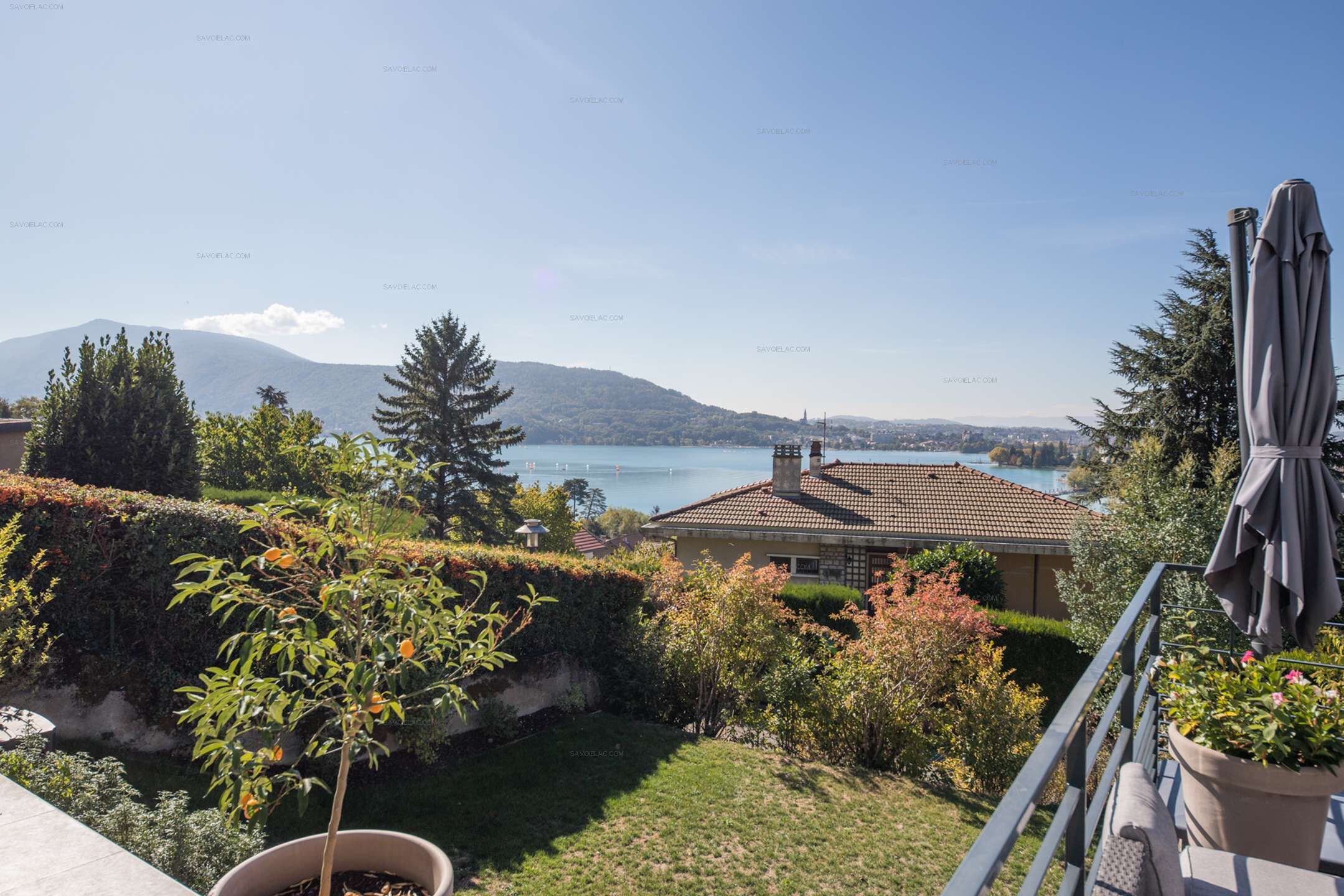 A residential property with a view of a lake and mountains.