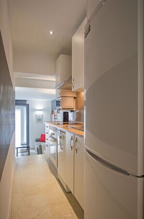 Enjoy cooking in this well-equipped kitchen with a refrigerator, microwave, and coffee maker.