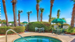 A hot tub surrounded by palm trees and greenery, with signs indicating no diving and no life guard on duty. - Romantic Oceanfront View, Discounted, Pools (Myrtle Beach)