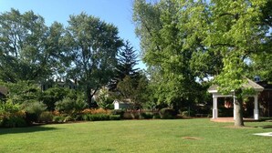 A well-maintained lawn with a brick pathway leading to a gazebo. - John Bruff Waterview Cottage - on Harbor and on Park - In Town St. Michaels! (Saint Michaels)