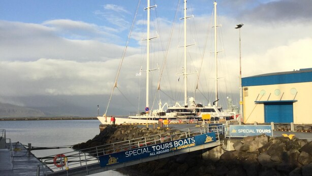 A large sailing ship docked at a pier with a sign reading "SPECIAL TOURS BOATS ALL ABOARD FOR ADVENTURE!". - Downtown Apartment by Old Harbor (101 Reykjavík)