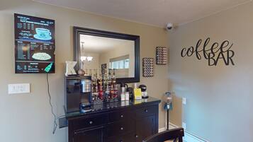A coffee bar with a menu board, a mirror, and a wall sign saying "coffee bar".