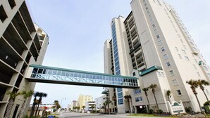 Um hotel de vários andares com uma ponte de vidro que liga dois edifícios.