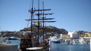 A harbor with a tall ship docked, surrounded by other boats and buildings in the background. - Loft Penthouse w/ terrace, WIFI, grill,  3min walk to beach, few blocks to dwtn (Cabo San Lucas)