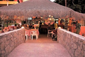 Guests can dine under a unique roof structure in a semi- outdoor setting.