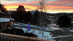 A residential area with snow-covered ground, a clear sky, and a distant mountain range. - PICTURESQUE BLUFF SIDE APARTMENT IN HOME (Colorado Springs)