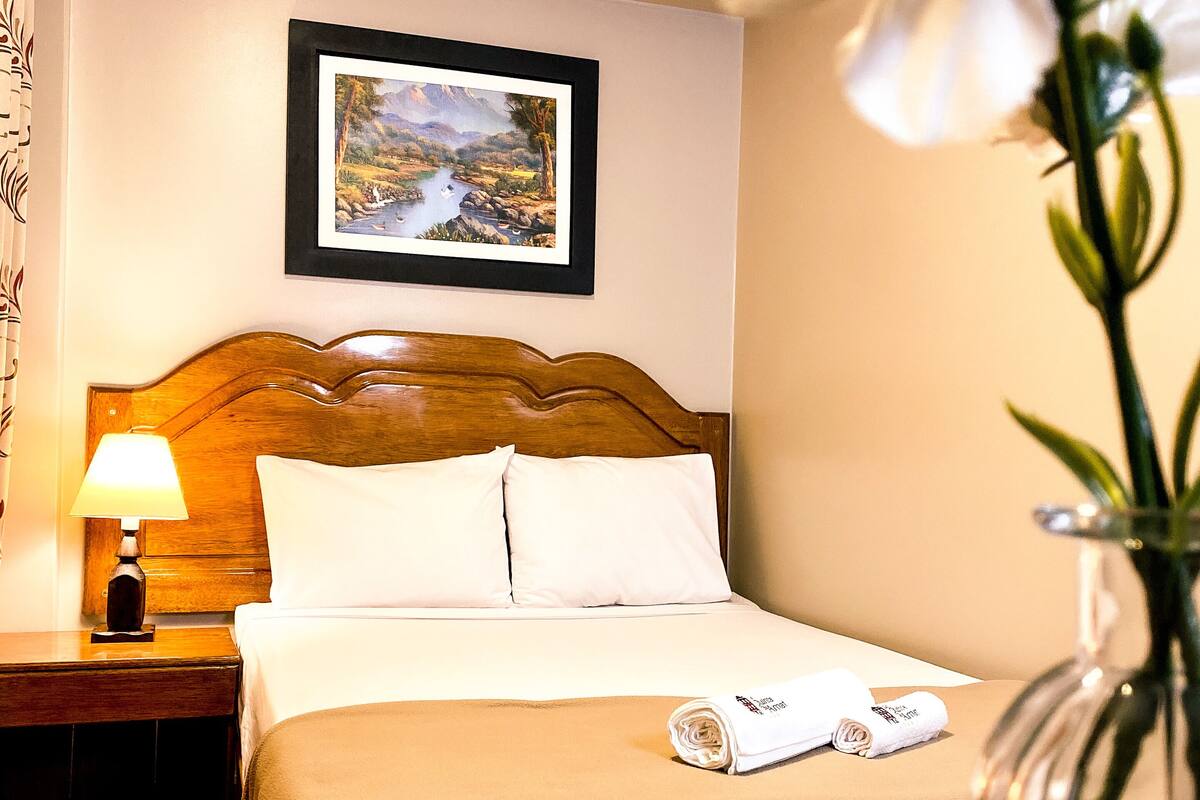 Premium bedding, desk, laptop workspace, blackout curtains