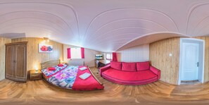 A room with a curved bed, a red sofa, wooden paneling, a television, and a door. - VeLa (Malý Slavkov)