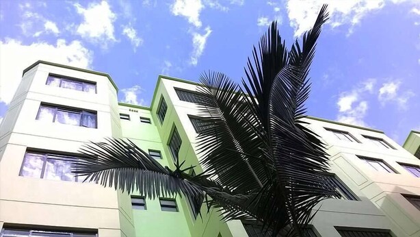 A multi-story building with a modern architectural design, featuring a prominent palm tree in the foreground. - Pinnacle Court Apartments (Nairobi)