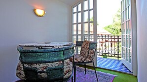 A room with a table and chairs, a large window, and a view of the outside.