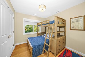 A bunk bed room with a window, a ladder, a dresser, and a chart on the wall. - 5 bdrm with pool - walk to the Harbor (Montauk)