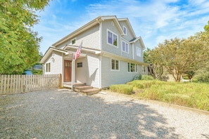 A two-story house with a front porch, a wooden fence, and a gravel driveway. - 5 bdrm with pool - walk to the Harbor (Montauk)