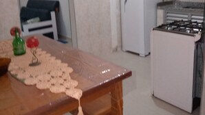 A compact kitchen with a refrigerator, stove, and dining table. - Sleeps 6 people, I love this place. (Jardim Praiano)