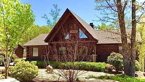A log cabin with a triangular roof, surrounded by trees and rocks. - Wilderness Retreat Cabin- Lg Game Room, Private Hot Tub; 1 Mile to Thunder Ridge (Ridgedale)
