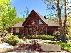 A log cabin with a triangular roof, surrounded by trees and rocks. - Wilderness Retreat Cabin- Lg Game Room, Private Hot Tub; 1 Mile to Thunder Ridge (Ridgedale)