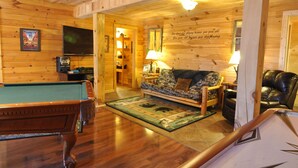 A cozy room with a pool table, a sofa, and a leather chair. - Wilderness Retreat Cabin- Lg Game Room, Private Hot Tub; 1 Mile to Thunder Ridge (Ridgedale)