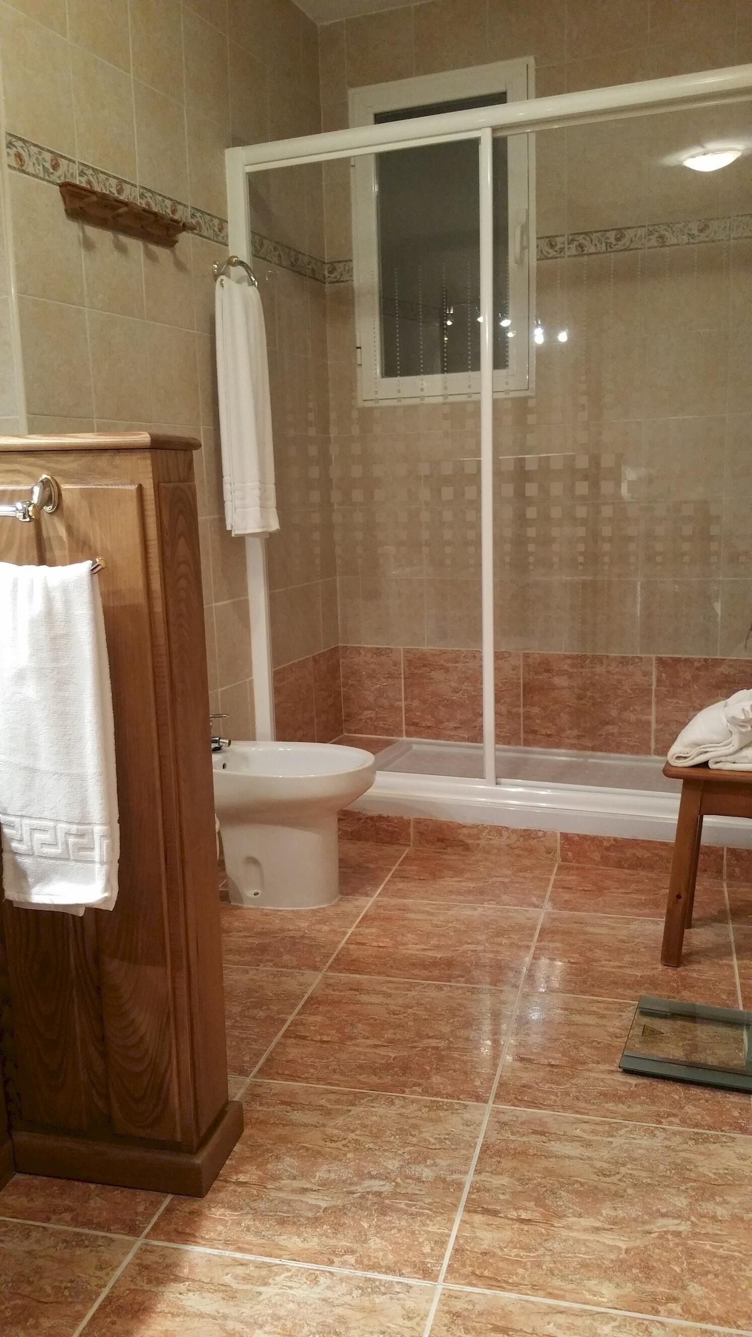 Un baño con ducha, inodoro y lavamanos.