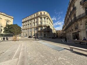 A historic building with a curved facade, large windows, and a prominent entrance. - Stylish, modern apartment in the historic centre of Montpellier. (Montpellier)
