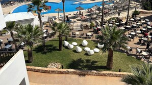 A resort with a pool area, lounge chairs, and palm trees. - 2 Bedroom, 2 bathroom front line property in Cala D'or (07660 Cala D'or)