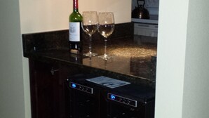 A kitchen with a wine bottle and two glasses on the counter. - Luxury, New Home - Serene and Private Vacation Oasis - Minutes from Siesta Key! (Sarasota)