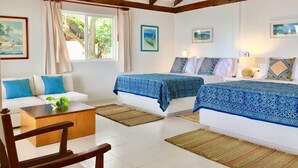 A room with two beds, a sofa, a coffee table, and a window with curtains. - Isla Venado. Private Island in Cholon, Cartagena. (Cartagena)