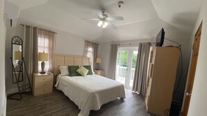 A bedroom with a bed, a ceiling fan, a dresser, and a wardrobe. - Amazing Property Close To Beaches/Golf Course/Railway Trails (Warwick)