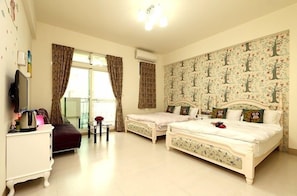 A bedroom with two beds, a dresser, a TV, and a window with curtains. - Flower 4 B&B (Hualien City)